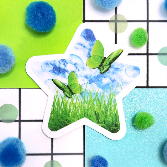 Star-shaped sticker with butterflies, green grass, and a blue sky background