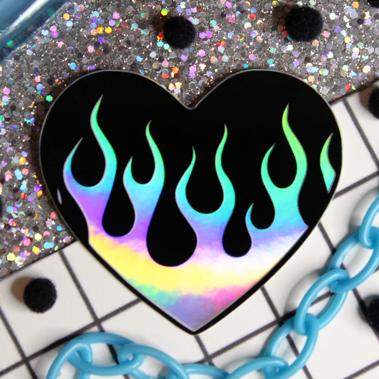 y2k aesthetic holographic flames on a black heart sticker