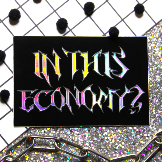 Holographic Metal font sticker with black background that says In this economy